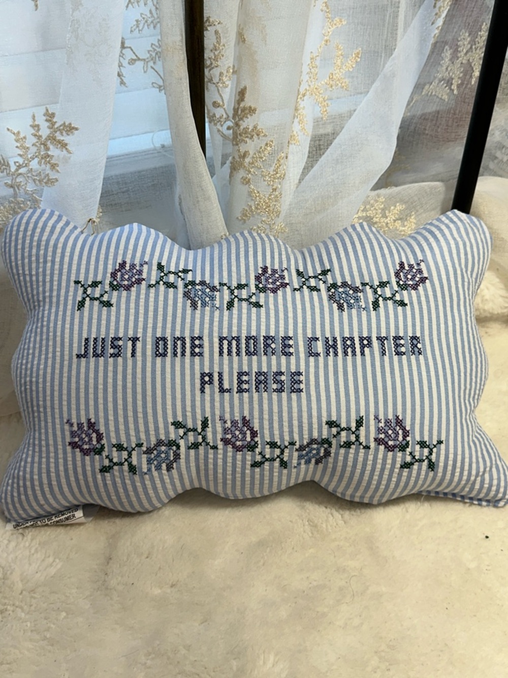 Embroidered “just one more chapter” deco pillow